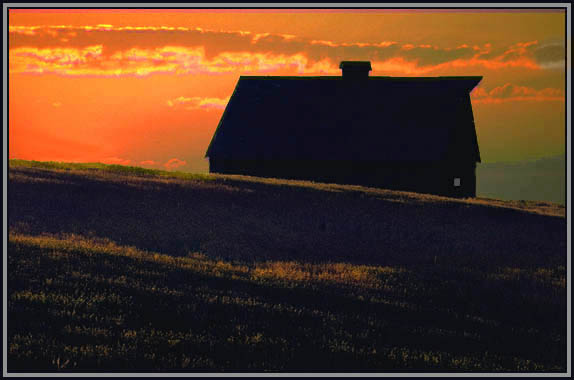Silhouette of a barn at sunset, WA